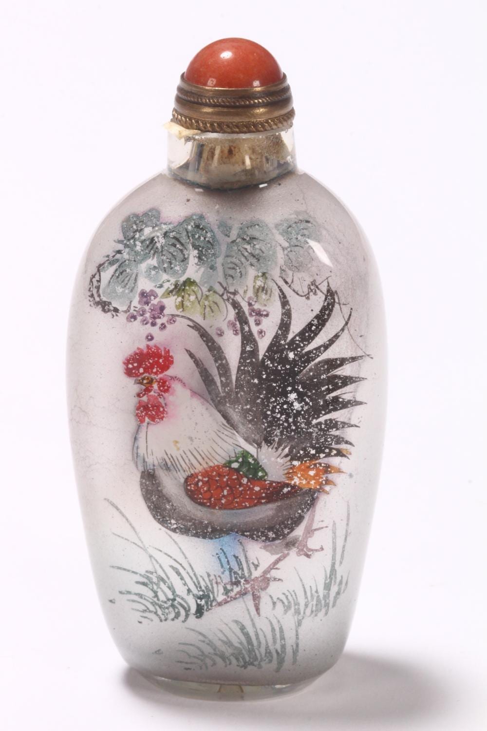 Small glass snuff bottle with a red stopper and colorful floral and bird decoration on the body.
