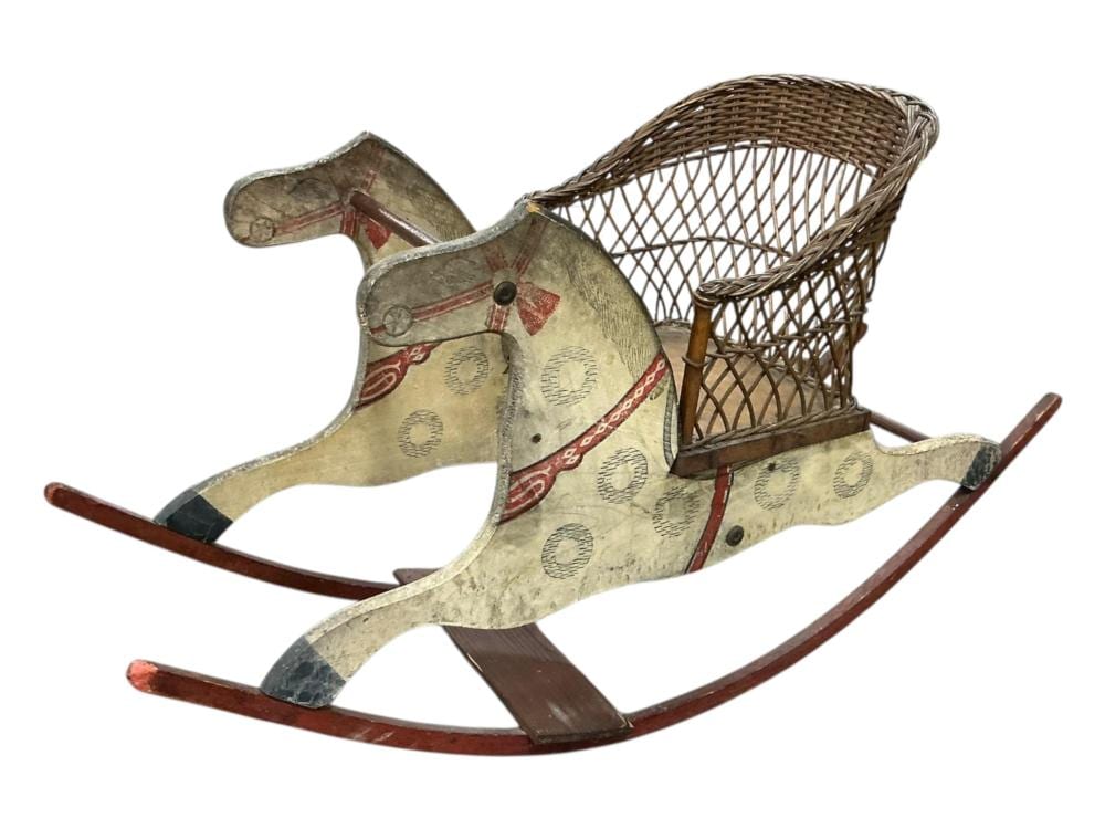 Primitive wooden rocking horse with two carved horse heads, painted saddle panels, and curved wooden rockers with brown trim.