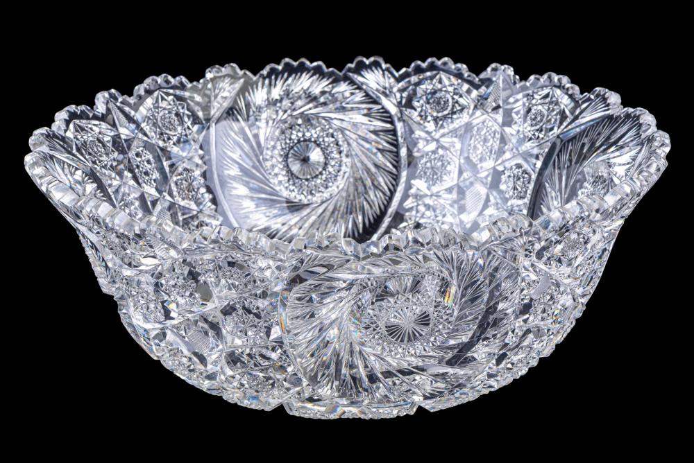 Cut crystal punch bowl with a flared rim and faceted patterns, shown on a dark background.