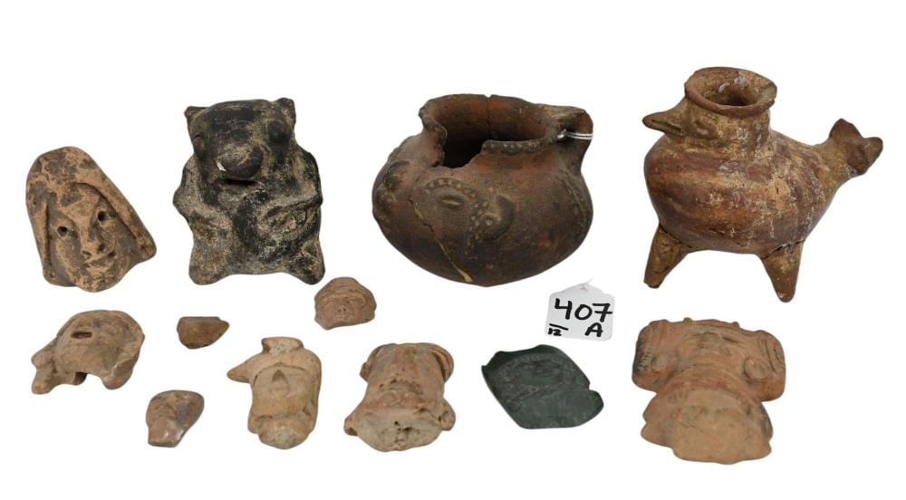 Photo of several small pre-Columbian-style pottery and stone fragments laid out on a white background.