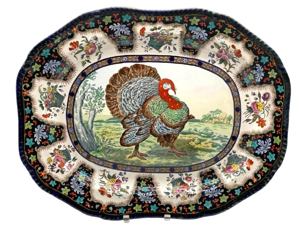 Oval porcelain turkey platter with a central painted turkey image and colorful floral border pattern.
