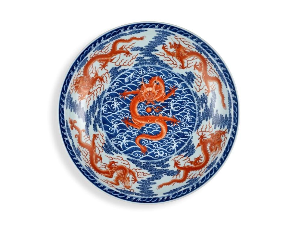 A fine and rare iron-red and underglaze-blue 'nine dragon' charger, Seal mark and period of Qianlong | 清乾隆 青花礬紅彩九龍圖折沿大盤 《大清乾隆年製》款 comparable sale