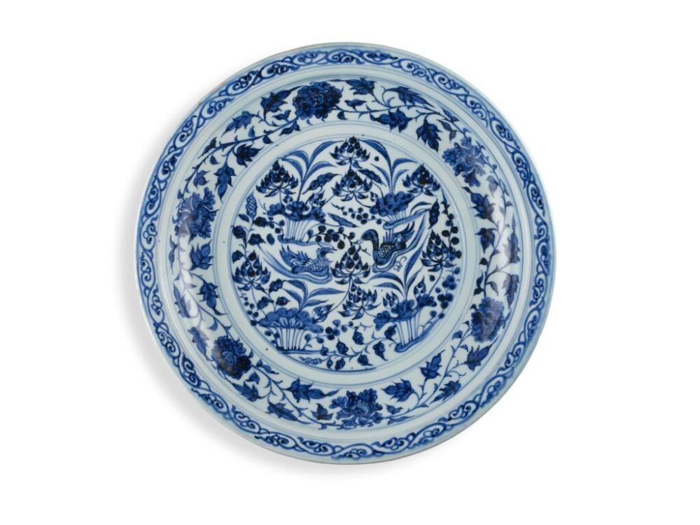 A rare blue and white 'mandarin duck' charger, Yuan dynasty | 元　青花荷塘鴛鴦圖折沿盤 comparable sale