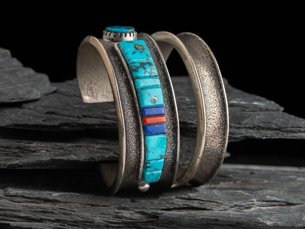 Edison Cummings comparable auction result: edison cummings din b 1962 tufa cast silver cuff bracelet with abstract figural inlay
