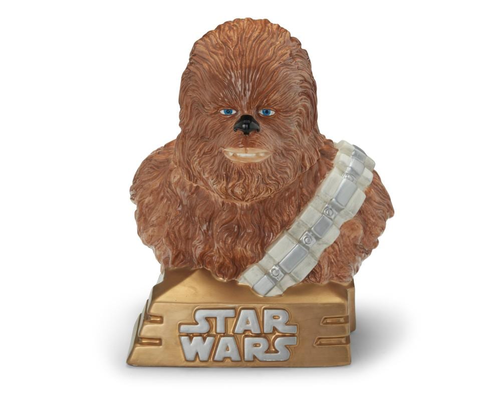 Ceramic cookie jar shaped like a brown Chewbacca-like character with blue eyes and a white guitar-like accessory, on a beige base reading “STAR WARS.”