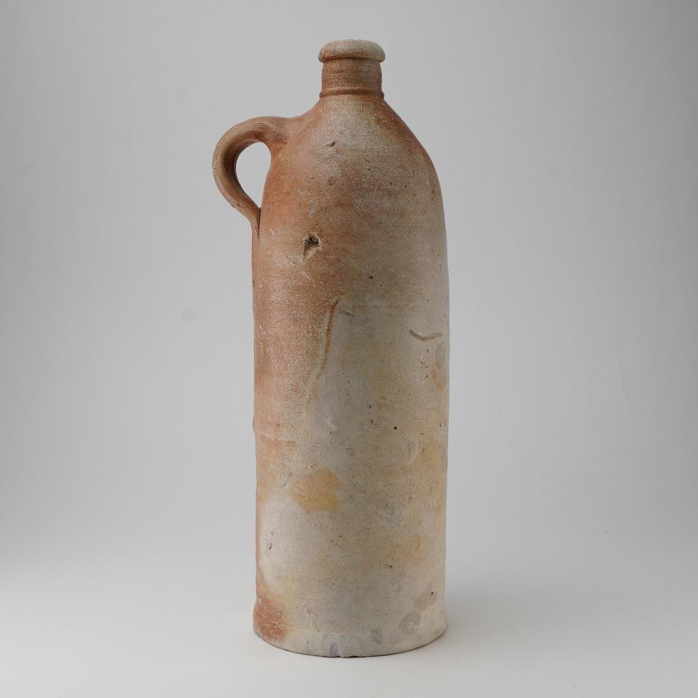 Antique-style ceramic jug with a narrow neck, rounded body, and single side handle, shown on a plain light background.