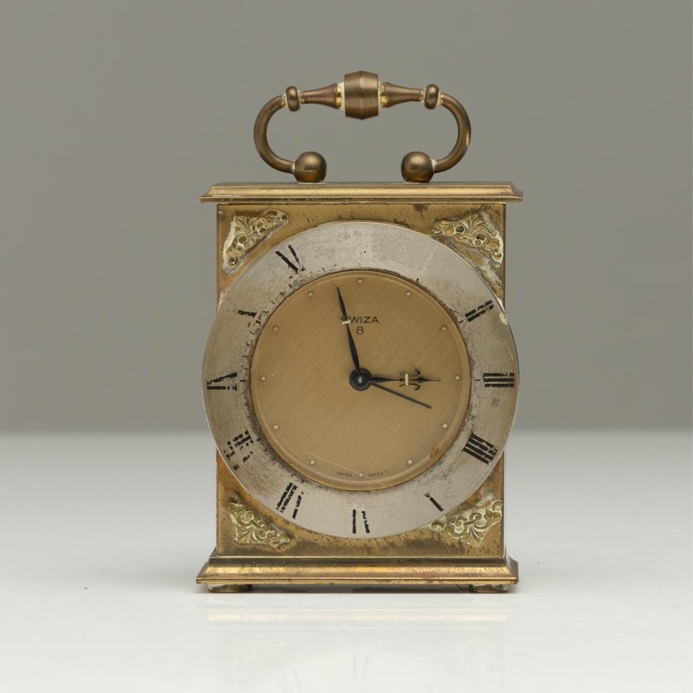 A small brass Swiza clock (H: 12cm - untested) sold by Lawsons, lot 403 — auction record photograph