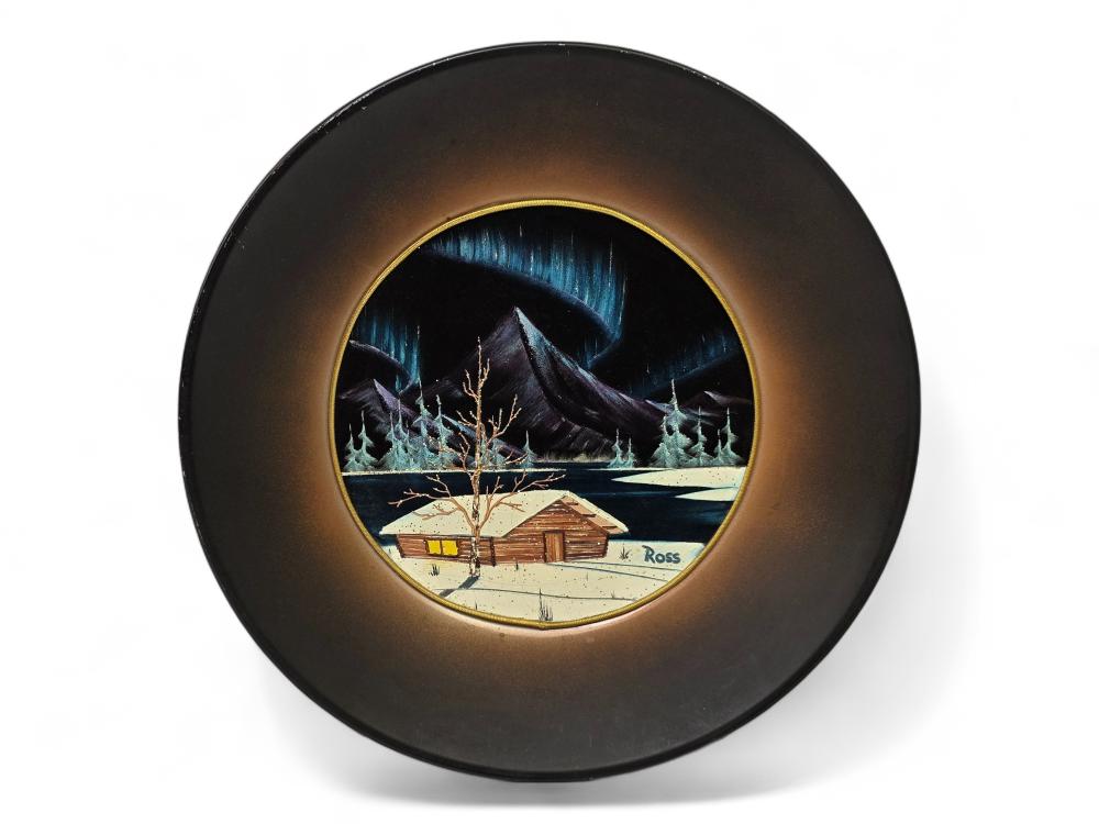 Circular framed winter landscape oil painting with a cabin, snowy trees, and mountains under a blue night sky.