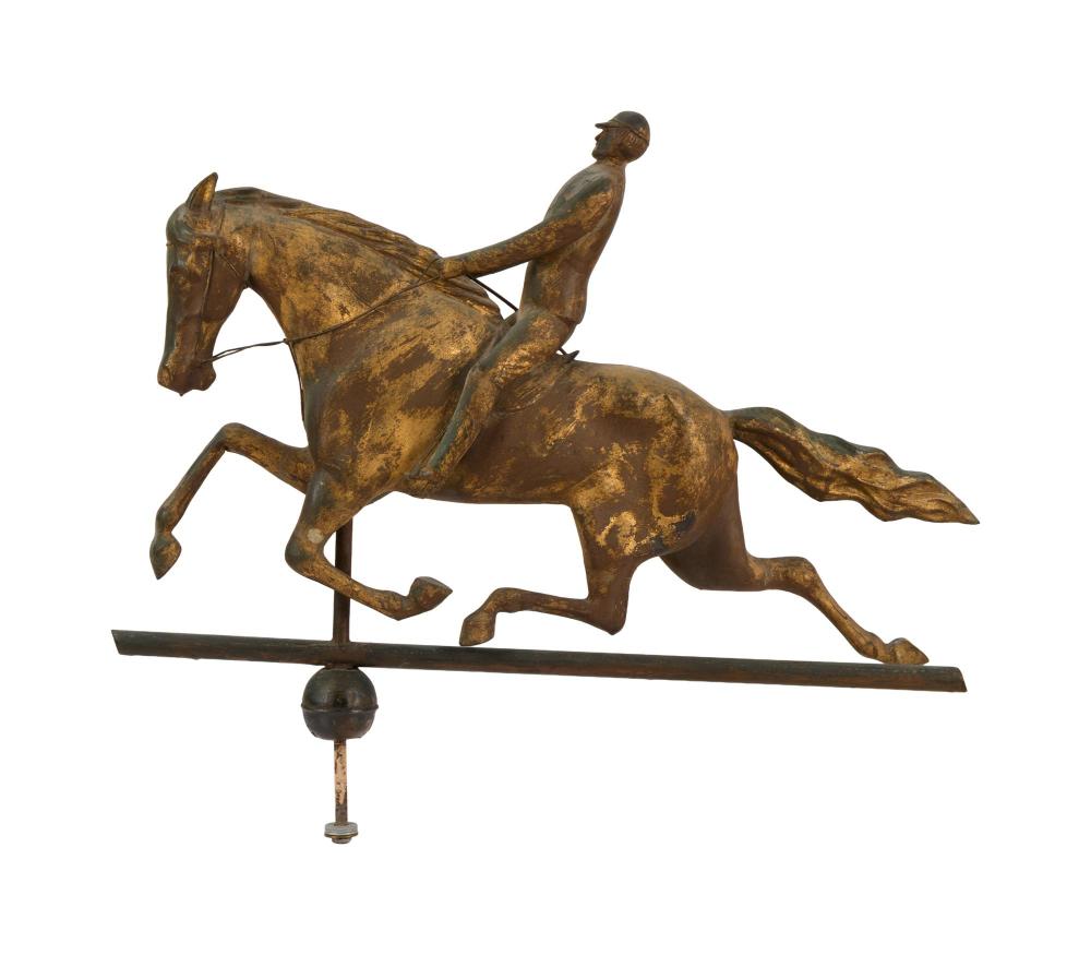 Antique-style bronze equestrian weathervane showing a rider seated on a galloping horse mounted on a metal base and rod.
