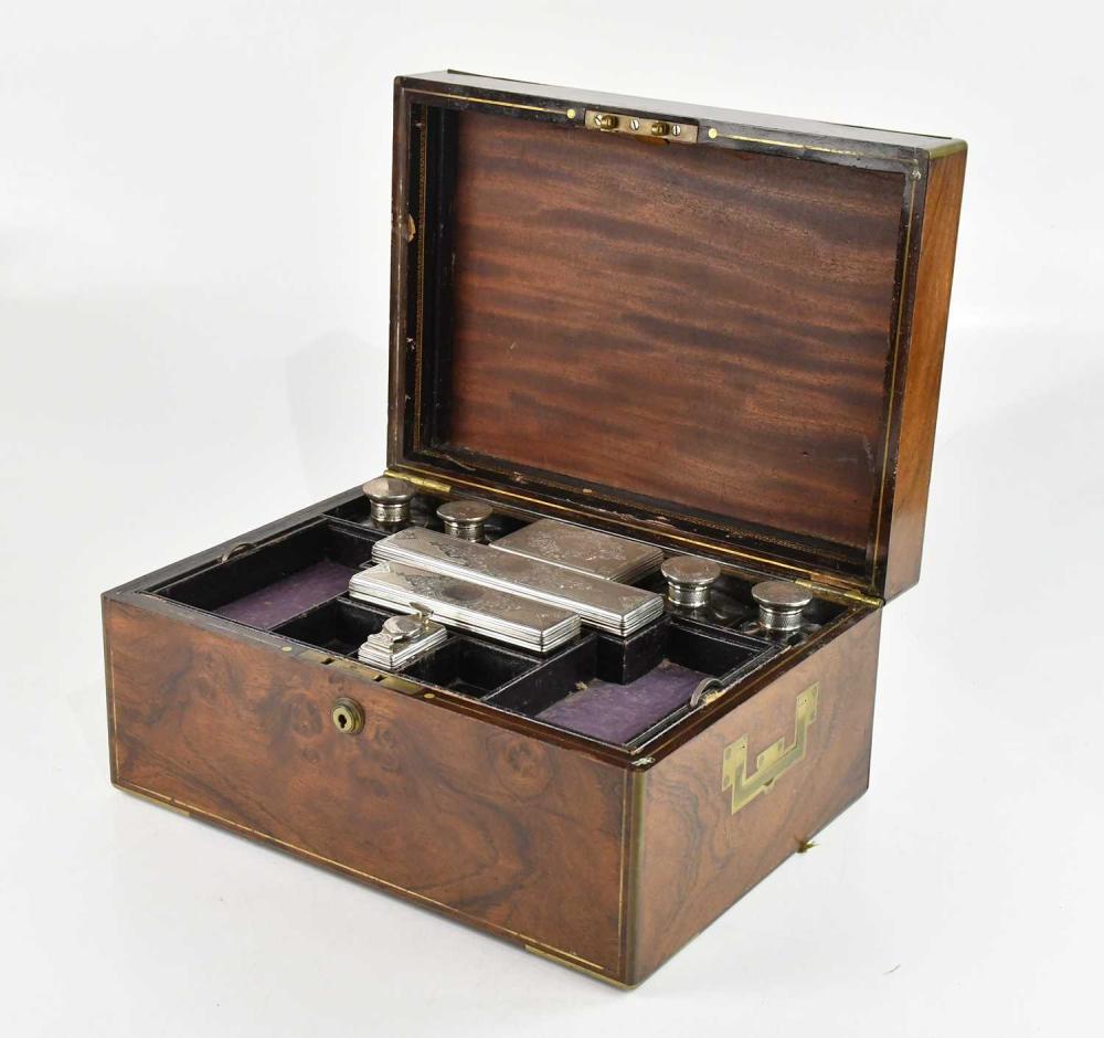 A 19th century brass bound campaign type travelling vanity case, with eight hallmarked silver topped dressing table jars, London 1865, height of box 17cm, width 35cm. sold by Adam Partridge Auctioneers, lot 290 — auction record photograph