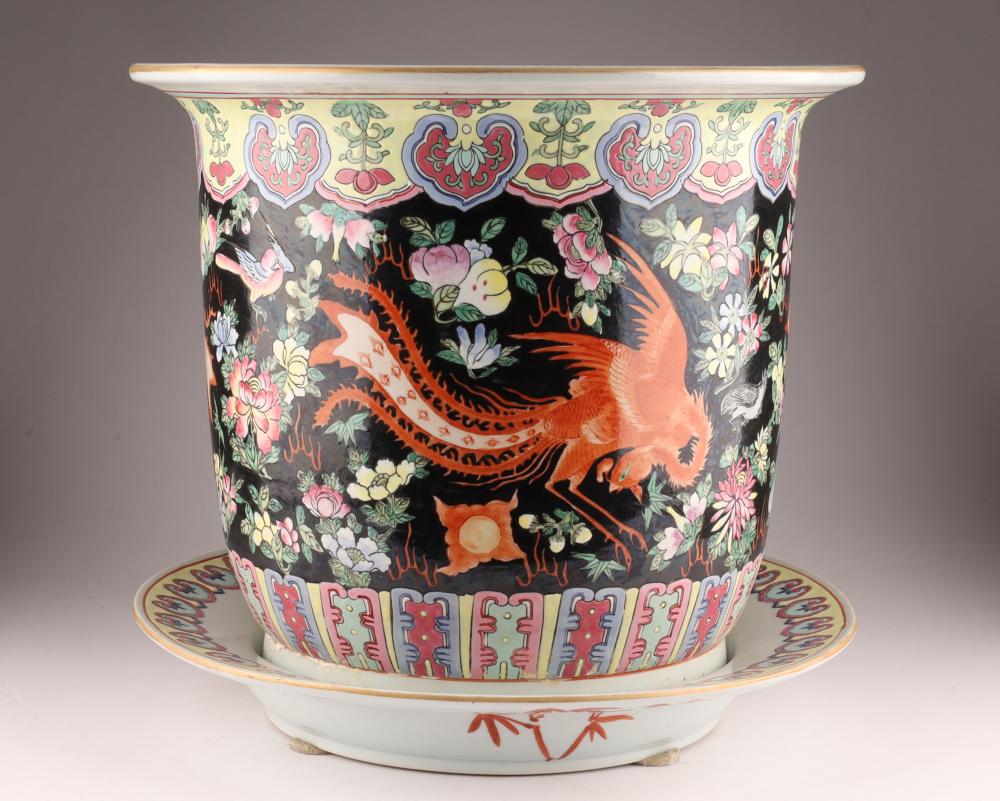 Chinese-style ceramic fishbowl planter with saucer, decorated in black with colorful flowers and orange fish and birds.