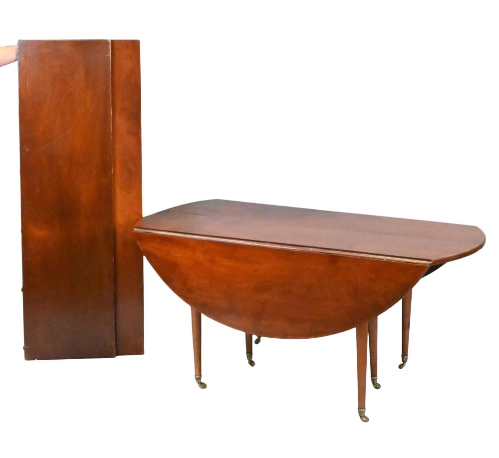Auction comp thumbnail for In the Manner of Maison Jansen Mahogany Drop-Leaf Dining Table with Two Leaves French mahogany dining table in the manner of Maison Jansen, with rounded drop leaves supported by swing gate-legs and extended with two ... (Nadeau's Auction Gallery, Lot 191)