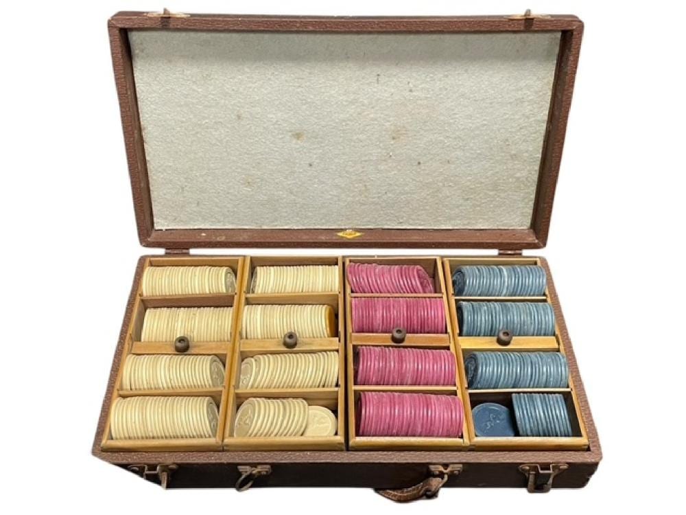 Open wooden case containing stacked red, blue, and yellow casino poker chips in separate compartments.