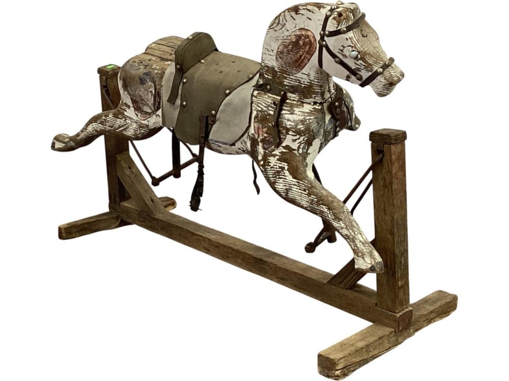 Wooden rocking horse with a gray painted body and dark saddle, mounted on a carved wooden rocker frame.