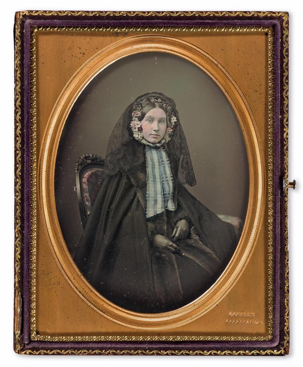 Jermiah Gurney comparable auction result: jeremiah gurney 1812 1895 a half plate daguerreotype of a woman with artfully tinted floral bonnet and blue ribbon