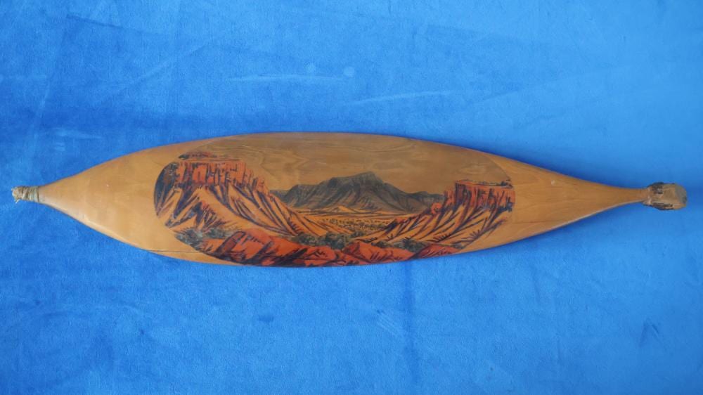 Oscar Namatjira comparable auction result: oscar namatjira hermannsburg watercolour on vernacular hardwood woomera macdonell ranges signed verso approx 58cm long note some splitting