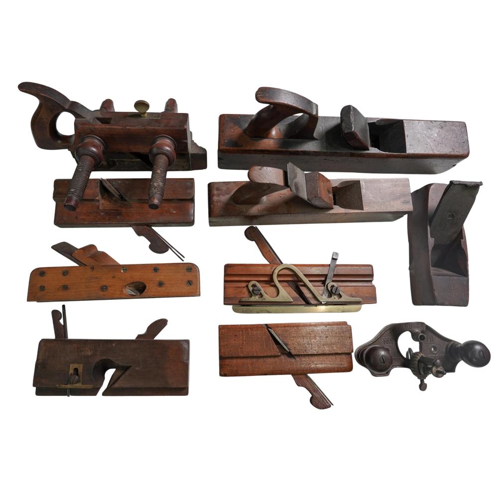 Set of antique-style hand woodworking tools and hand planes shown together on a white background.