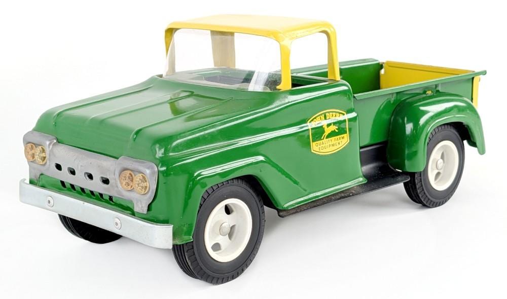 Green toy pickup truck with a yellow cab and open cargo bed on a white background.