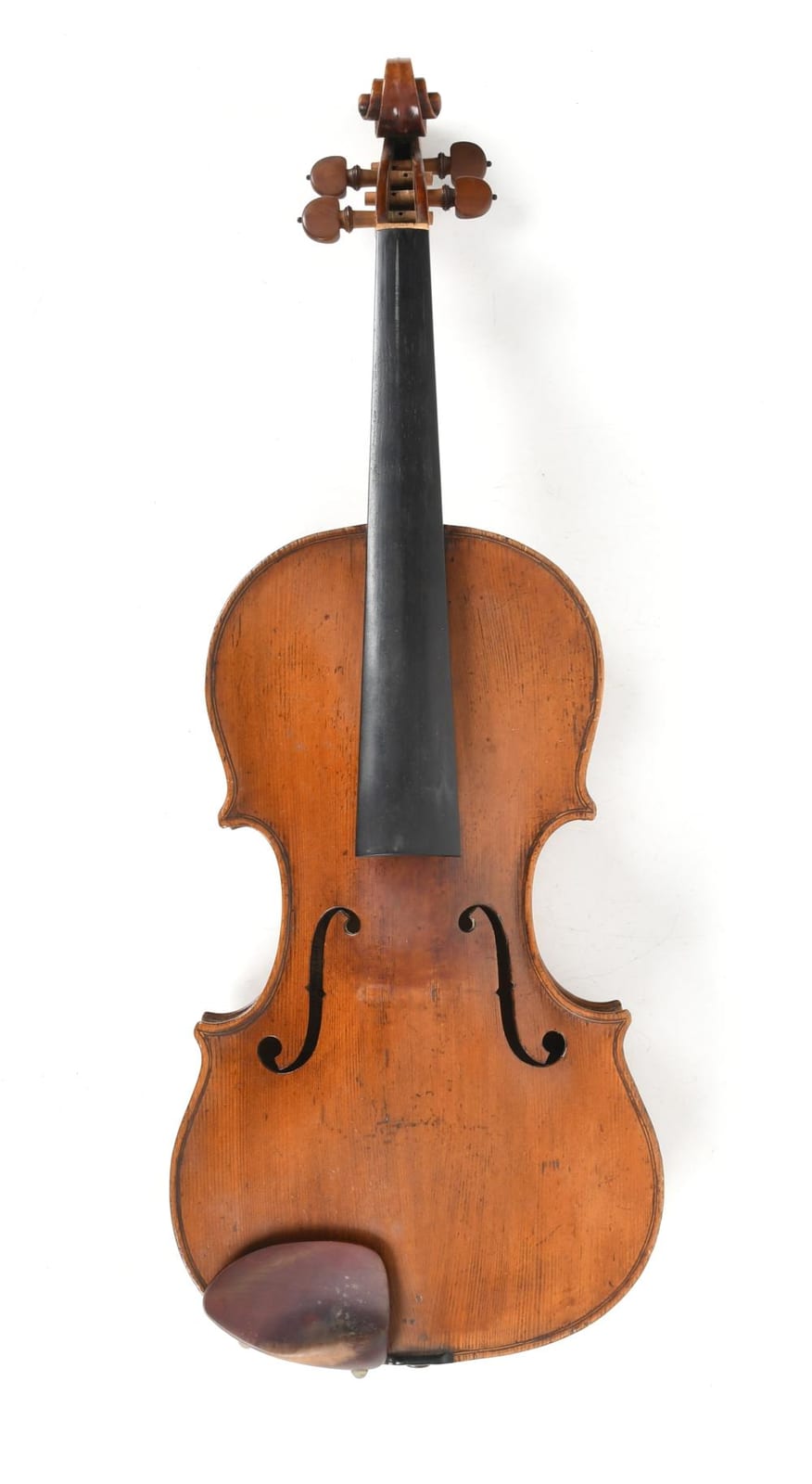 Back view of a brown wooden violin with curved outline, chin rest, and four tuning pegs on a white background.