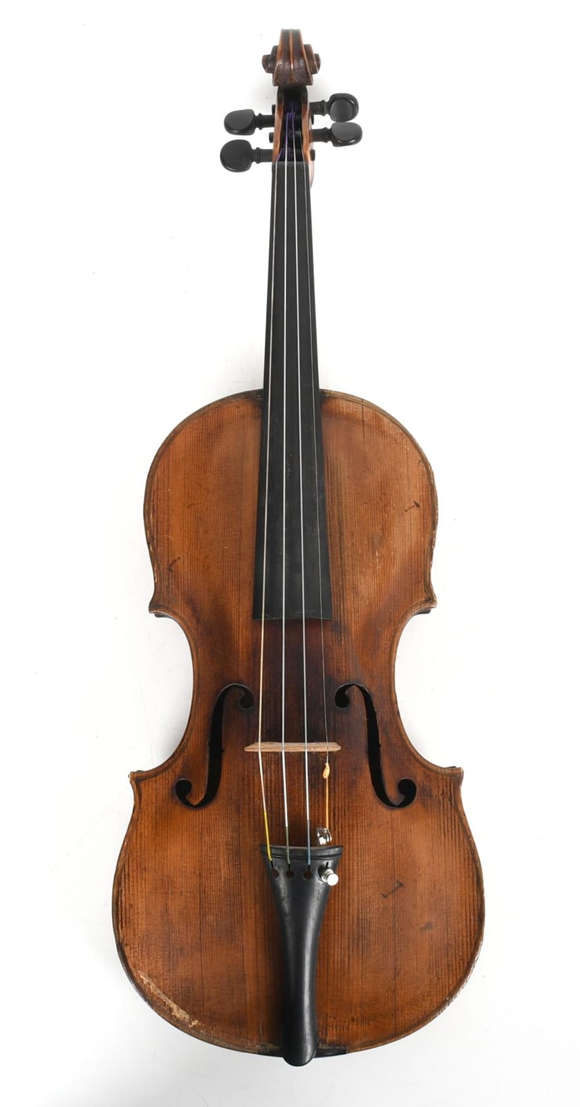 Front view of a wooden violin with dark f-holes, four strings, and a scroll on top.
