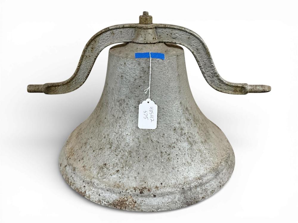 Large gray metal cast bell with a domed body and side loop handles, shown against a white background.