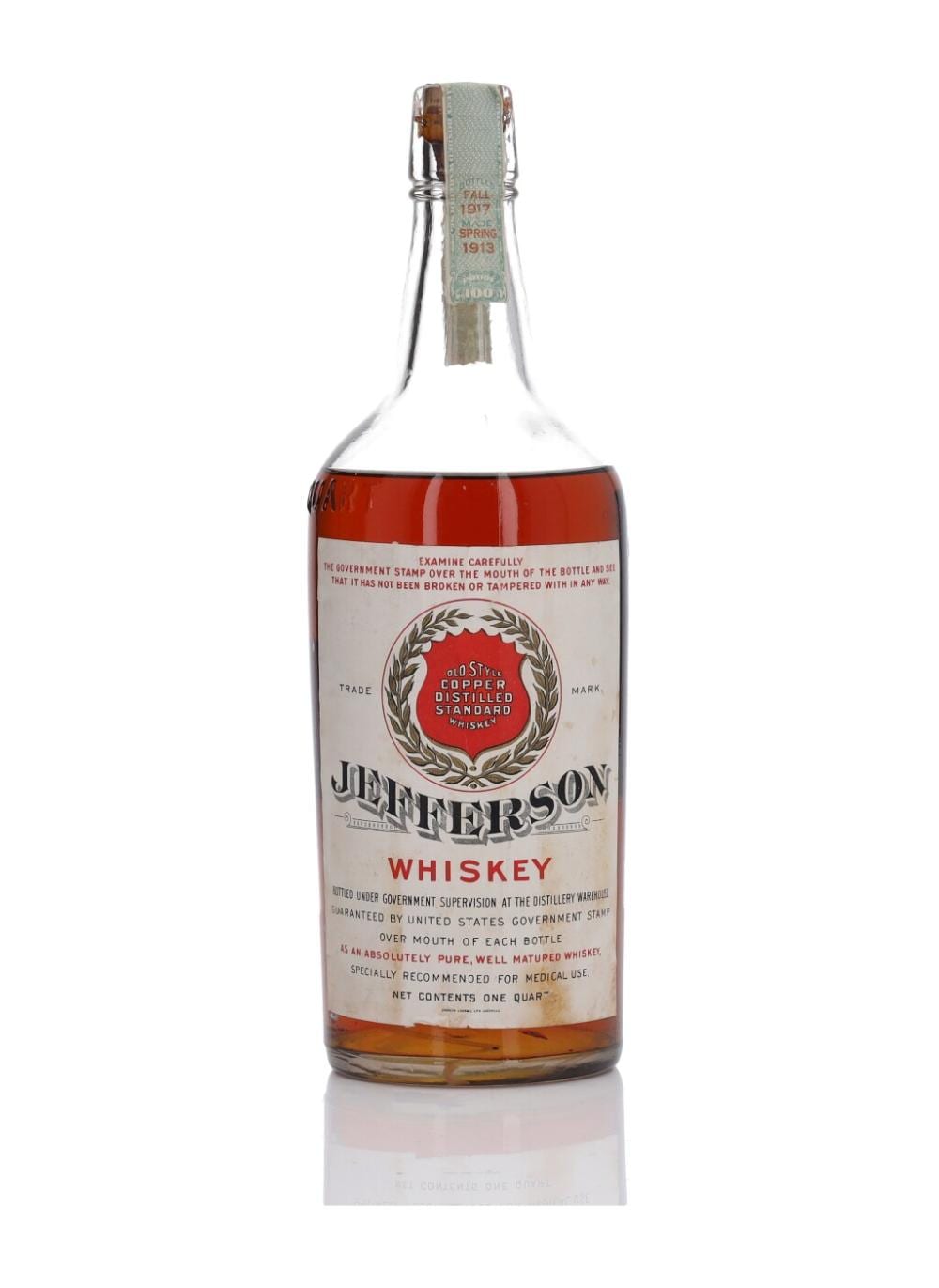 Glass whiskey bottle with amber liquid and a printed label that reads Jefferson Whiskey, shown against a white background.