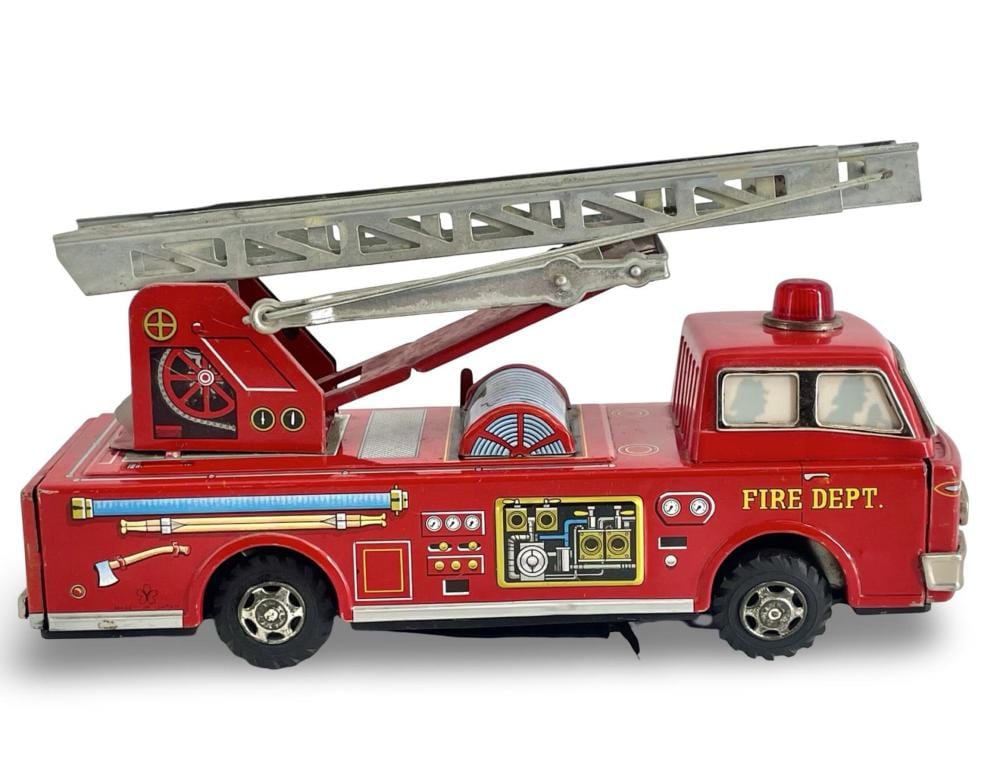 Red toy fire truck with extendable ladder on a base, showing “FIRE DEPT.” on the side.