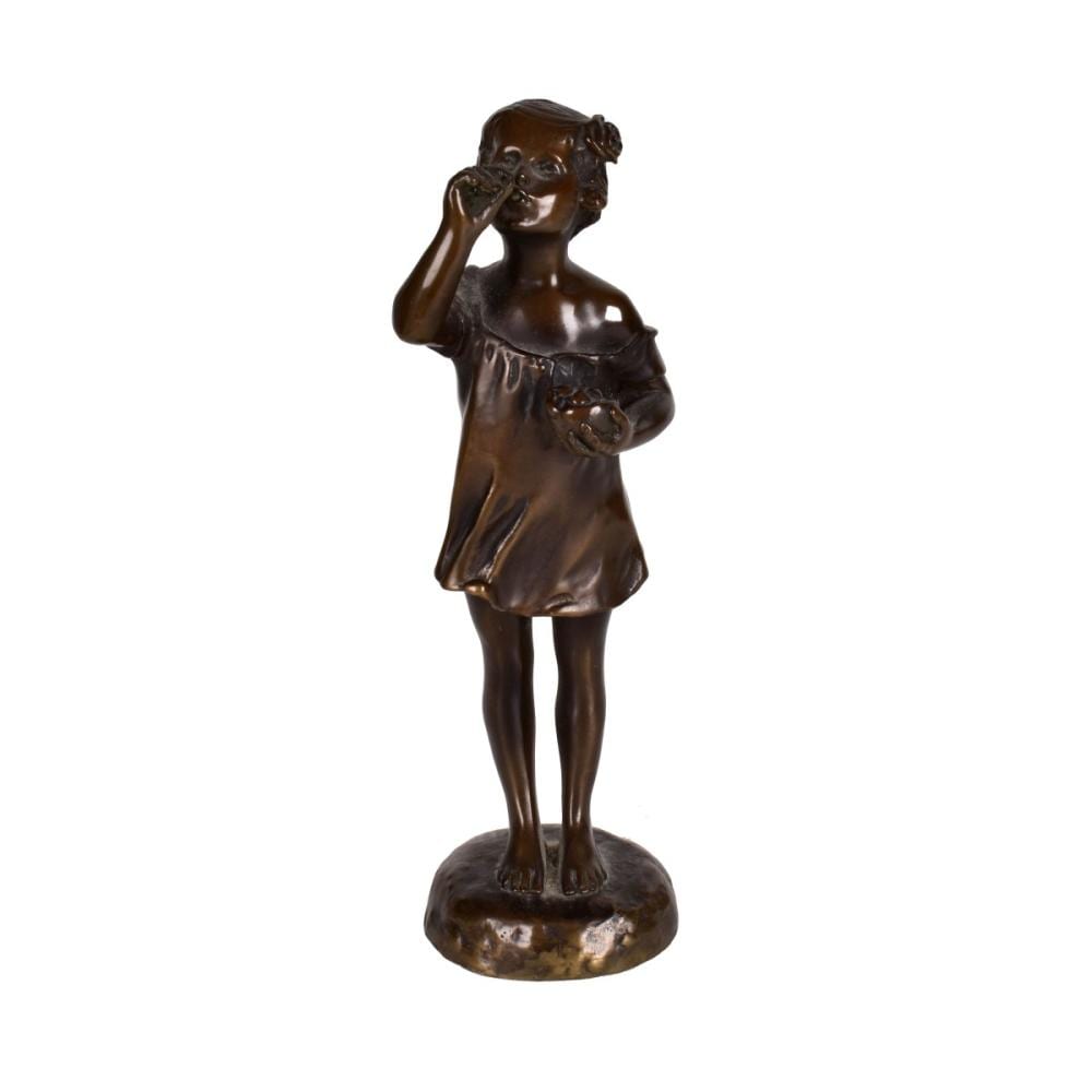 Small bronze sculpture of a standing young girl holding one hand to her face and a small doll or object in the other arm.