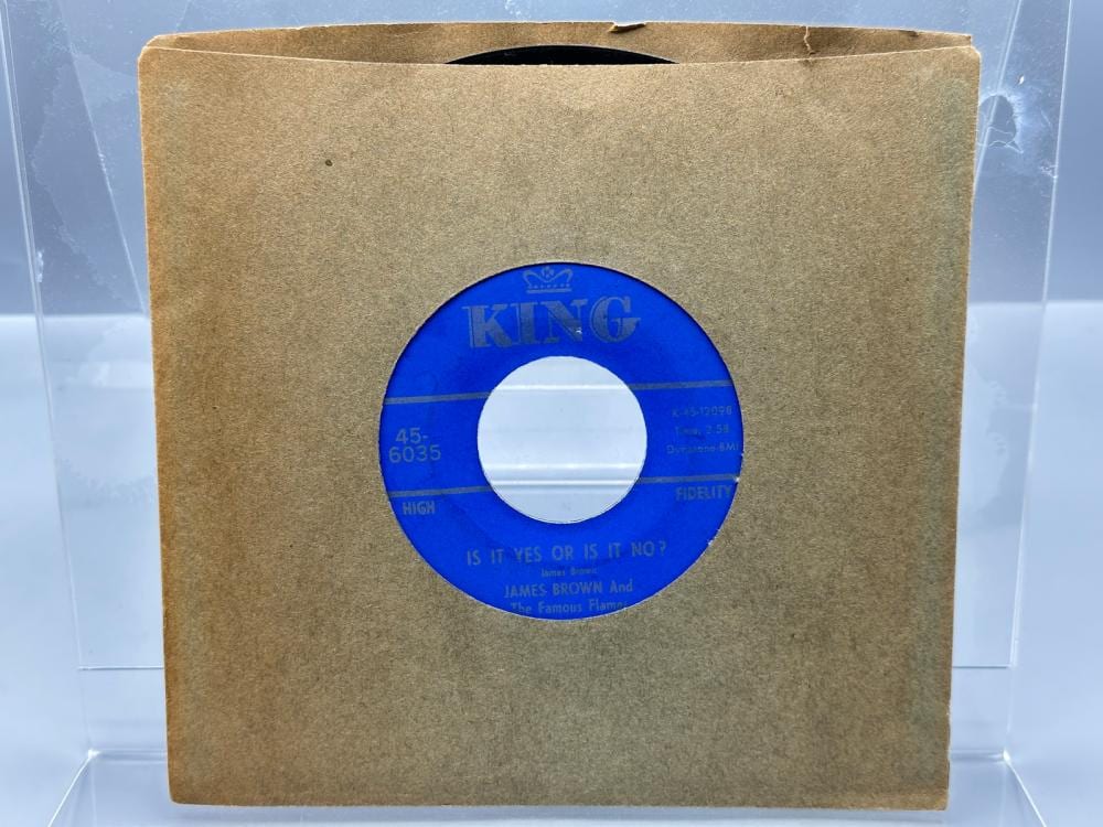 Blue-and-white 45 RPM vinyl record label centered on a brown paper sleeve, with “KING” branding and song text visible.