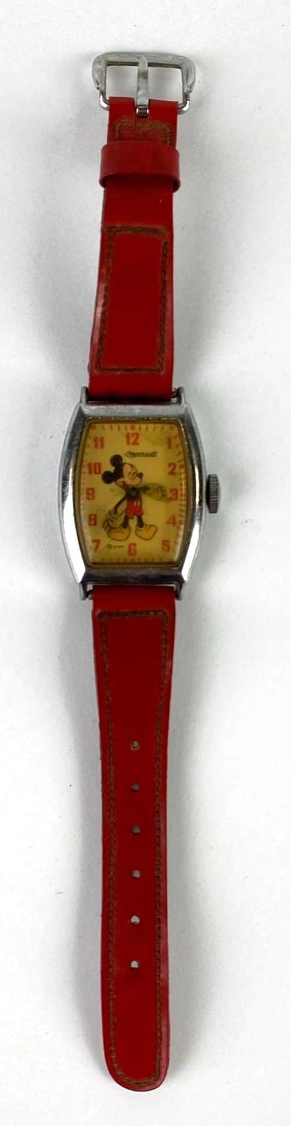 Red wrist watch with Mickey Mouse graphic on the dial and a red leather-like strap.