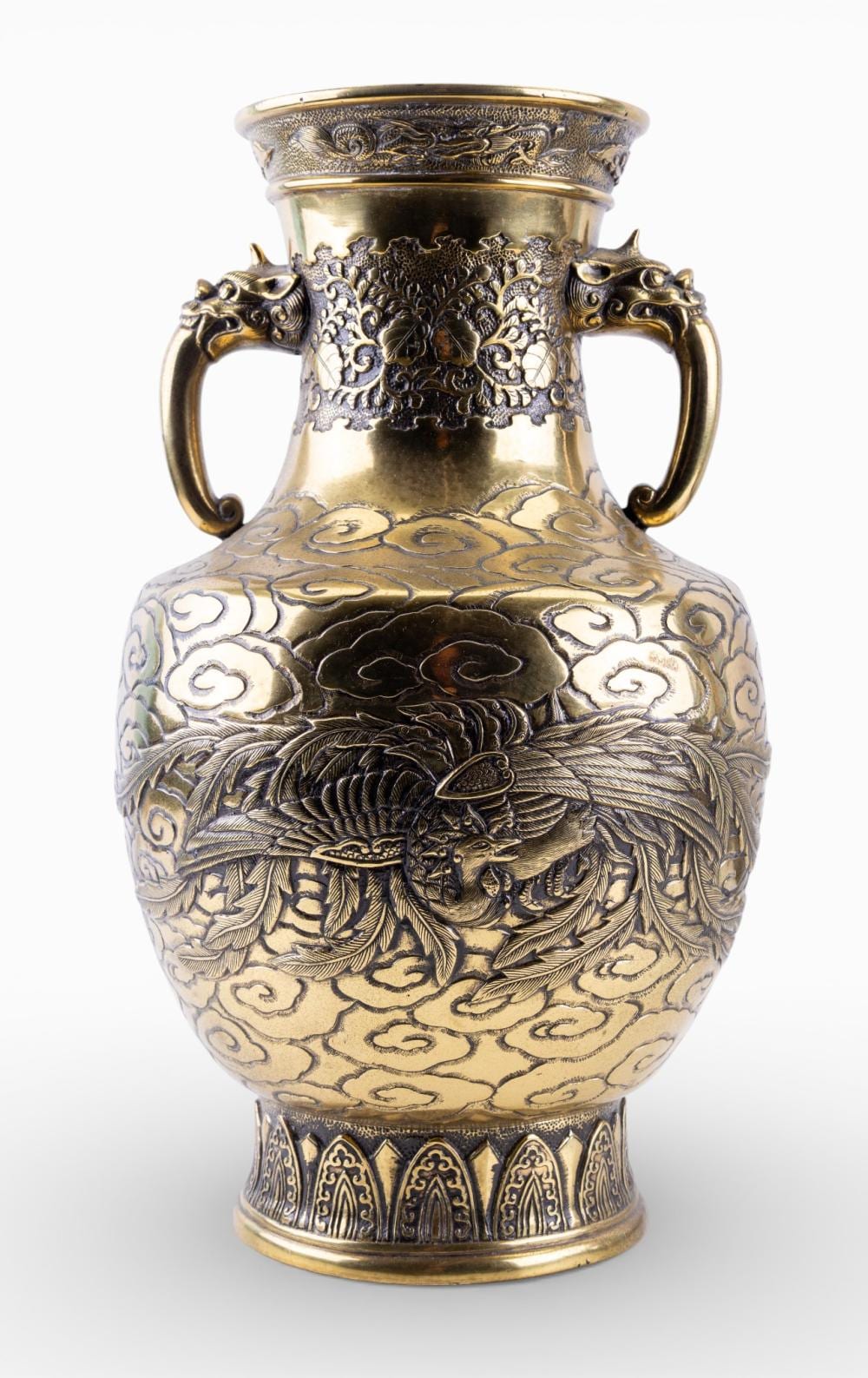 Metal vase with side handles and dense decorative relief.
