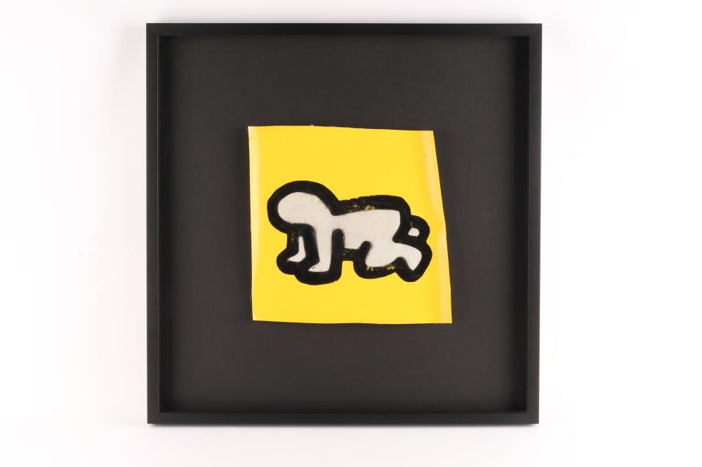 Framed yellow graphic fragment with a black-and-white crawling baby figure on a black background.