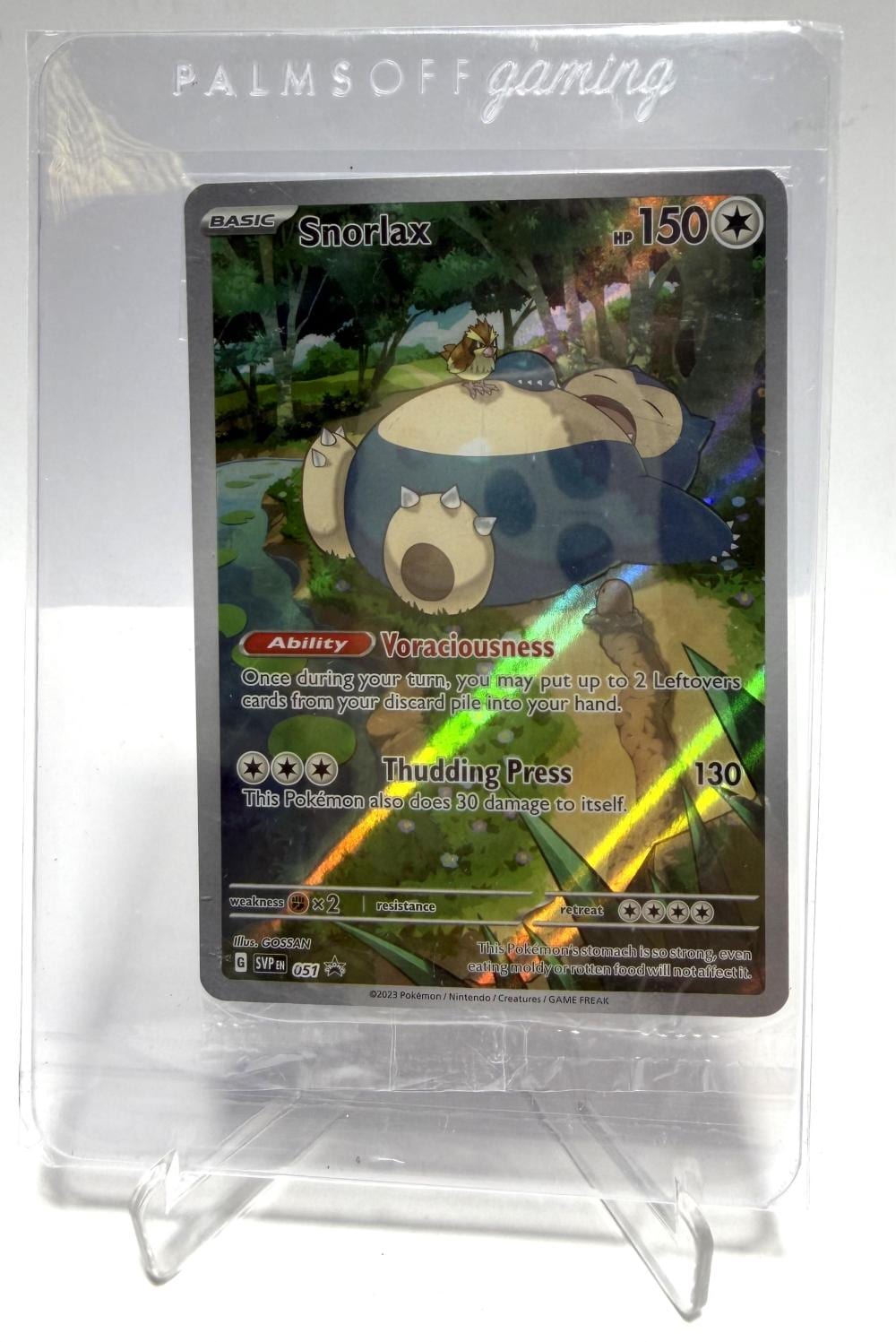 Pokemon Snorlax trading card in a clear plastic sleeve showing HP 150 and ability Voraciousness.