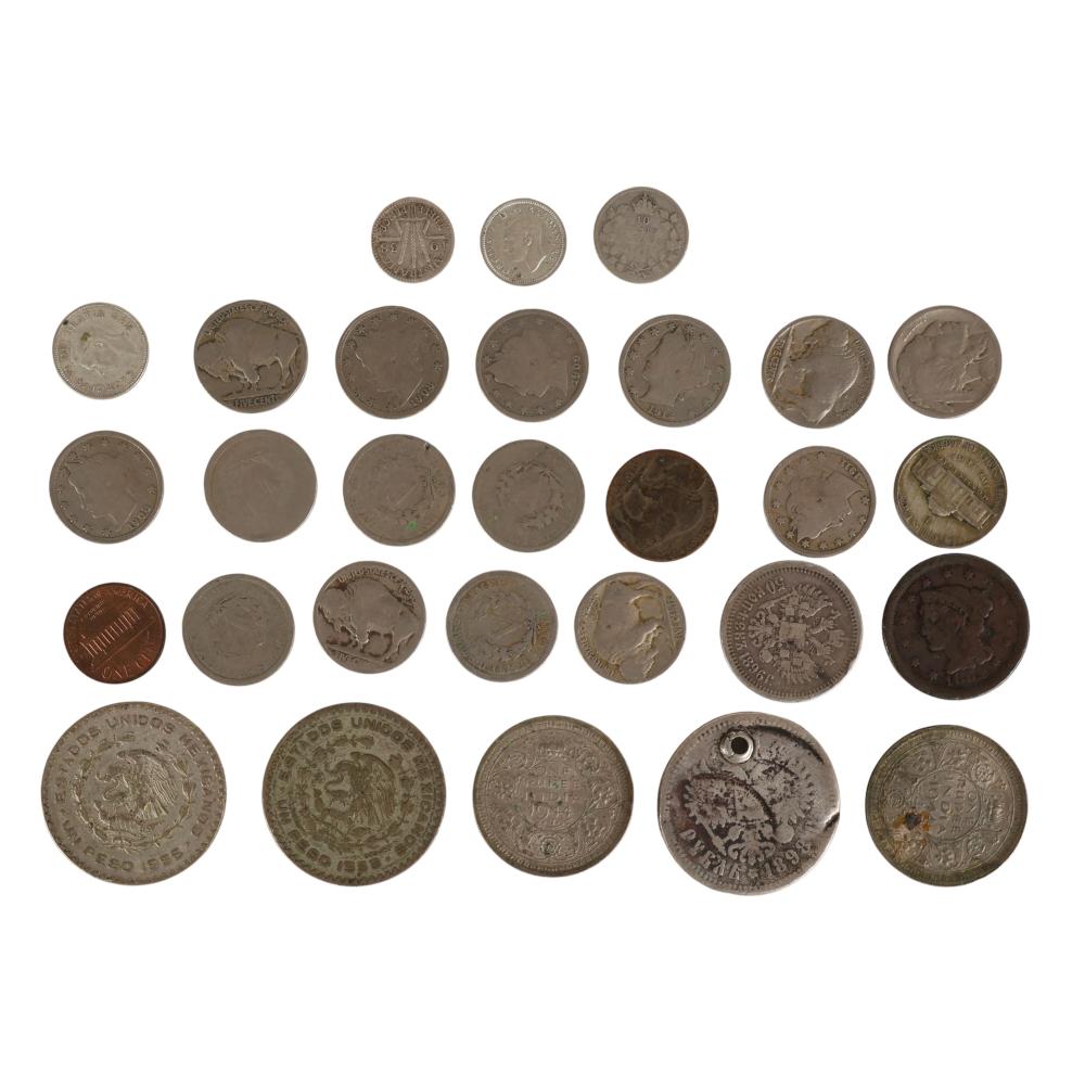 A group of assorted world coins displayed in rows on a white background, showing different sizes and designs.