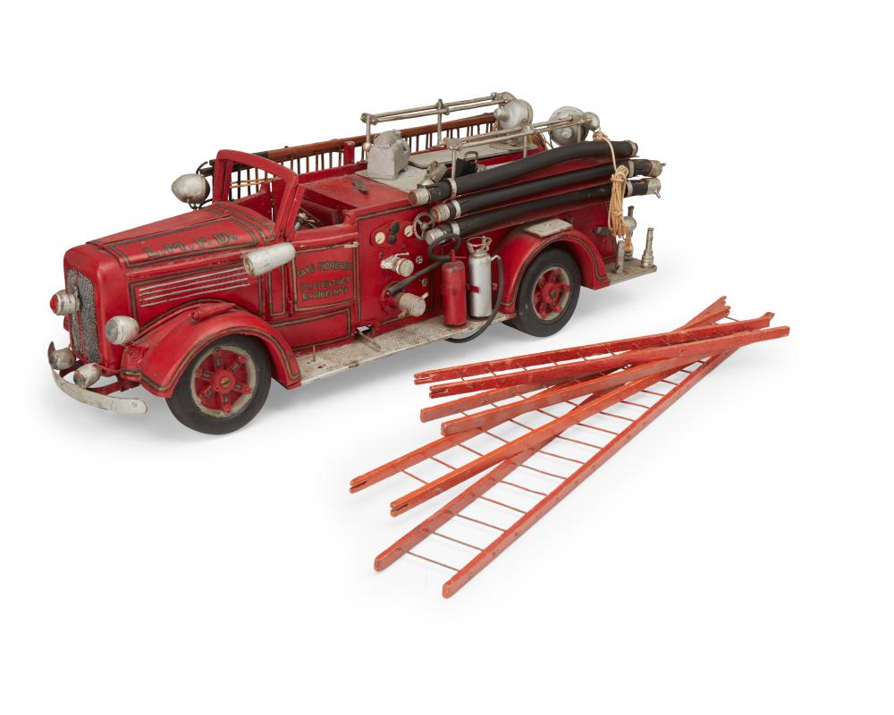 Red vintage toy fire truck with ladder and hoses, shown with two orange ladder rails laid on a white background.