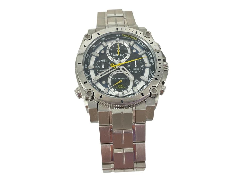 Metal wristwatch with a dark dial, multiple subdials, yellow accents, and a silver link bracelet.