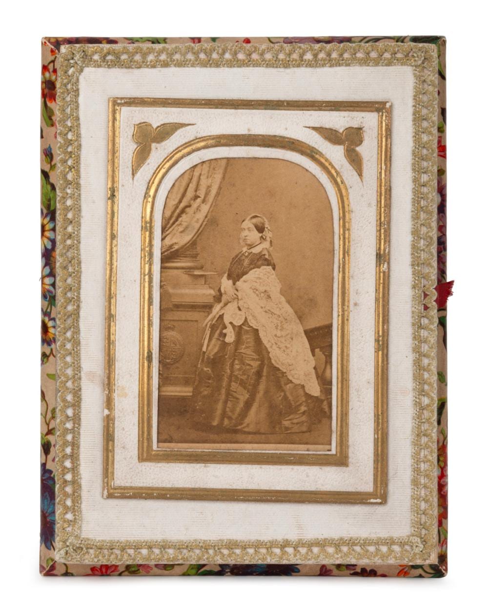 Decorative sewing box lid with a framed sepia portrait photo of a seated woman, surrounded by ornate gold trim and a floral patterned border.