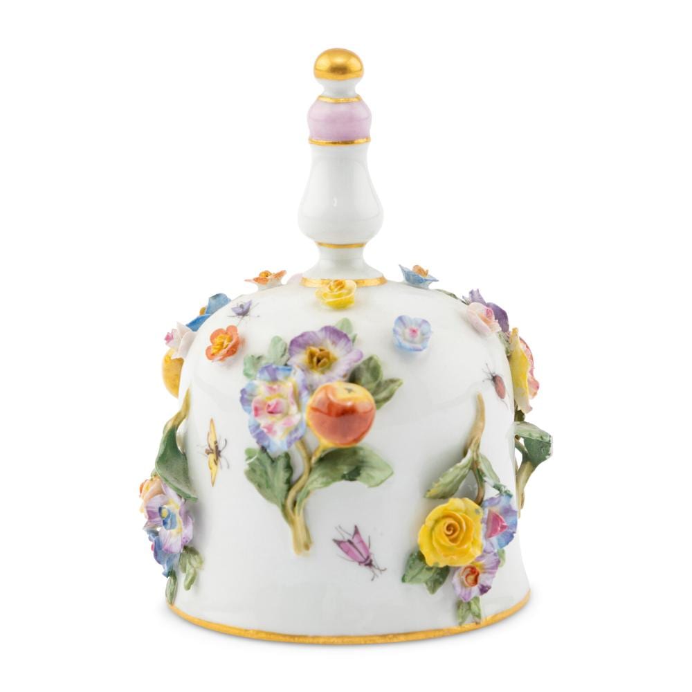 Porcelain dinner bell with floral painted decoration in colorful flowers and leaves, gold top knob, and gold trim around the base.