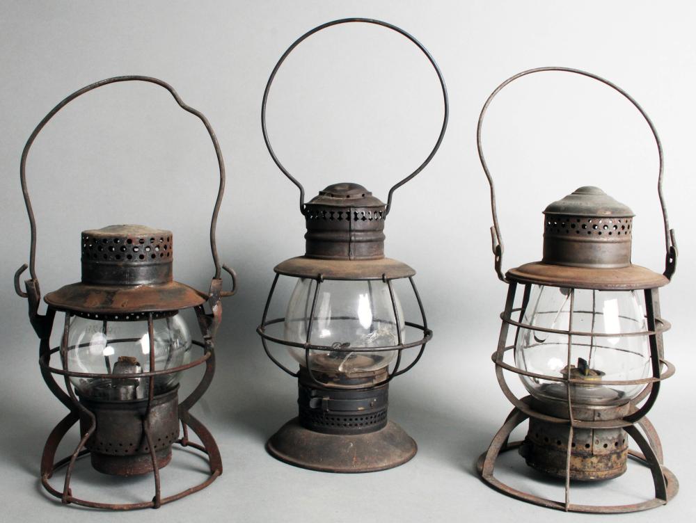 Auction comp thumbnail for (3) Antique Railroad oil lanterns, all complete: A PRR with clear unmarked cracked globe; a no name ‘Bell Bottom’ with clear broken globe; and a Dietz marked on short clear globe ‘B & O R R’ (Roan Inc. Auctioneers & Appraisers, Lot 268)