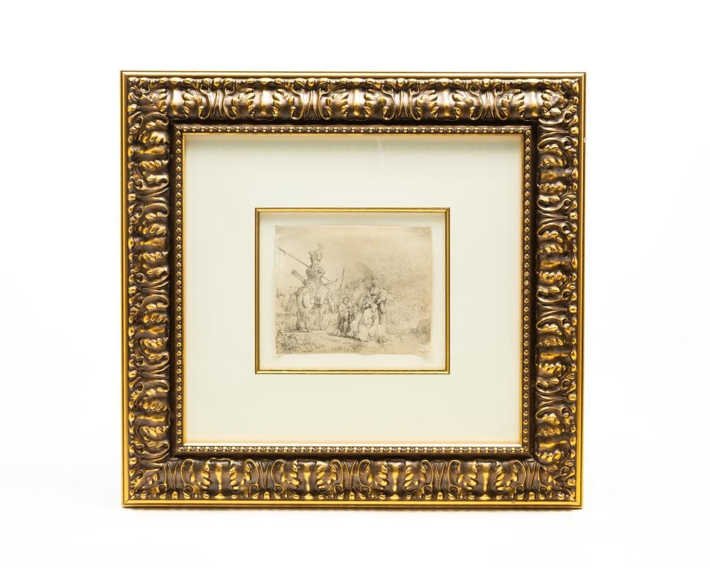 Framed black-and-white etching print showing a group of figures outdoors, with a small central scene and ornate gold frame.
