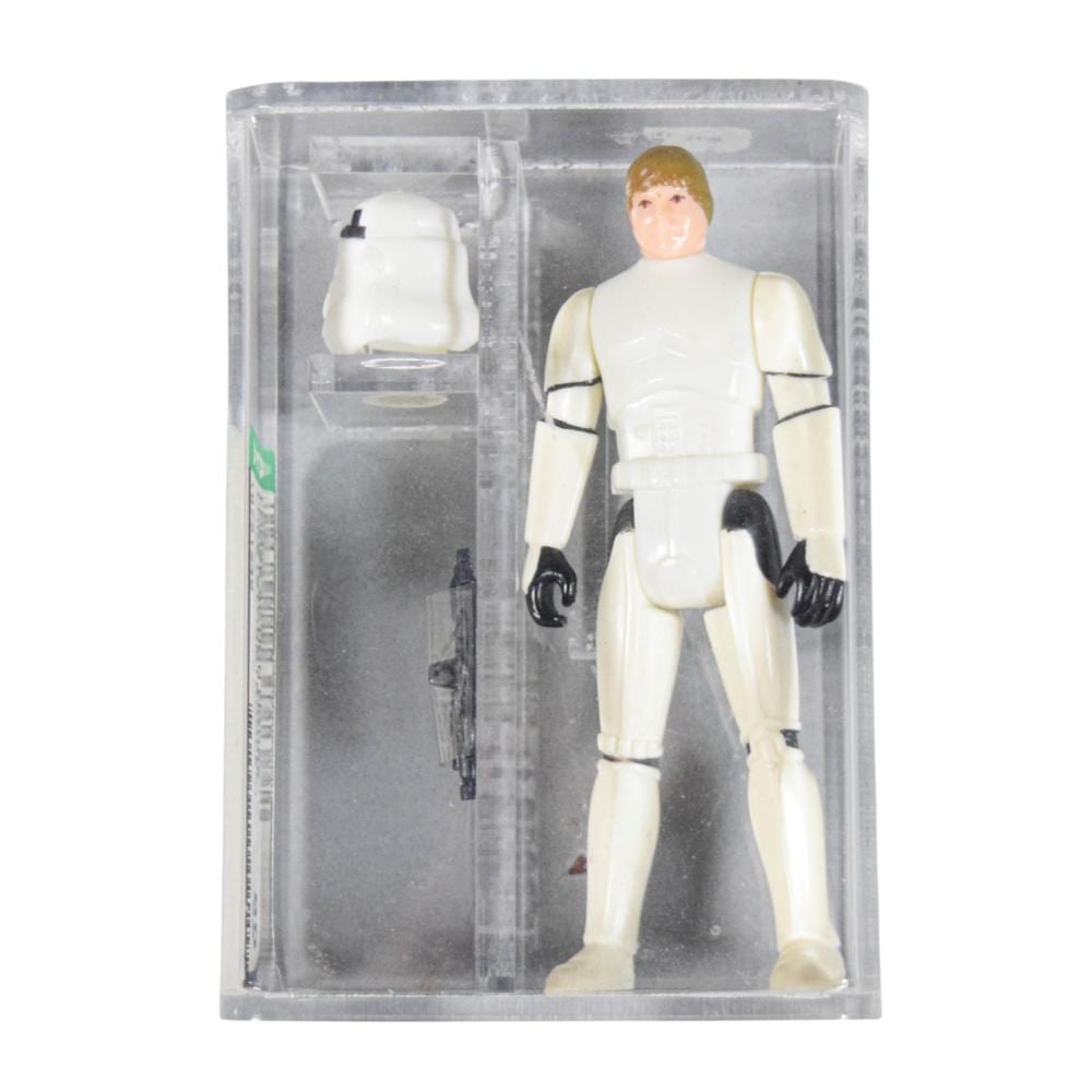 Boxed Star Wars style action figure in white armor with black gloves and belt, viewed front in a clear plastic case.
