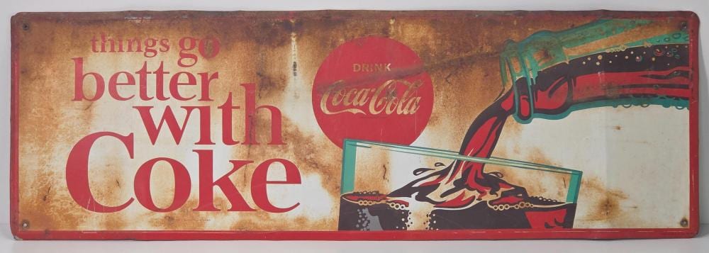 Vintage Coca-Cola themed sign with red lettering “things go better with Coke” and a soft drink bottle graphic on a rust-colored background.
