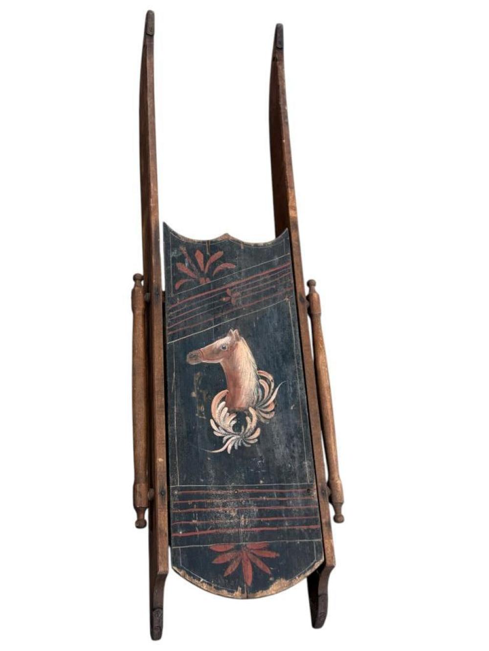 Antique hand-painted wooden sled with blue panel decorated by a horse and red floral motifs.