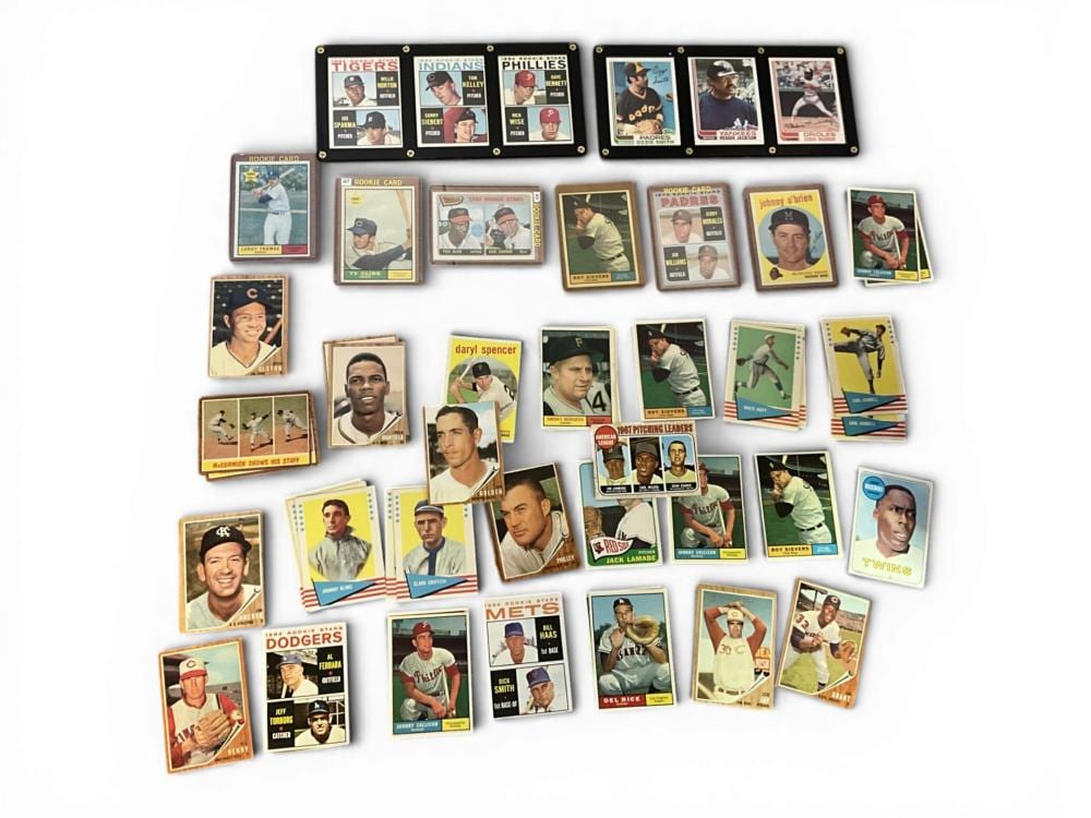 Assorted vintage baseball trading cards laid out in a group, with multiple players and teams shown.