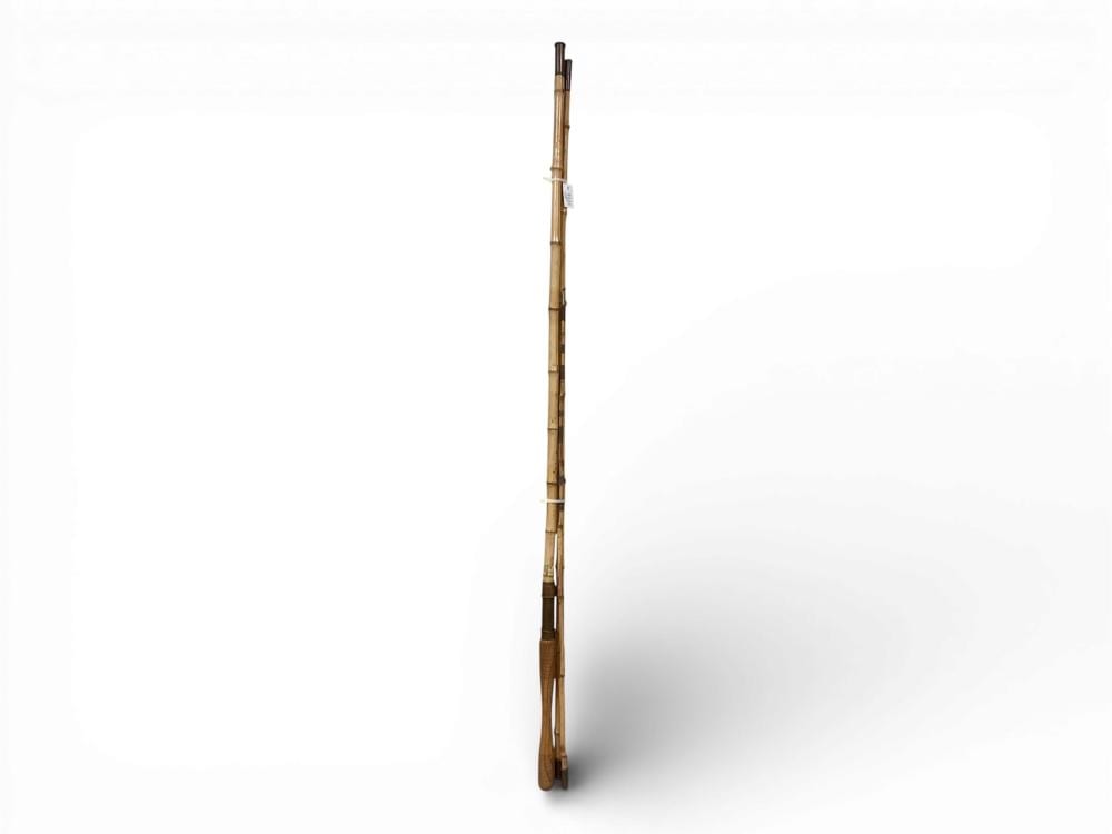 Tall segmented fishing rod with brown bamboo-like sections and a dark handle, shown against a white background.