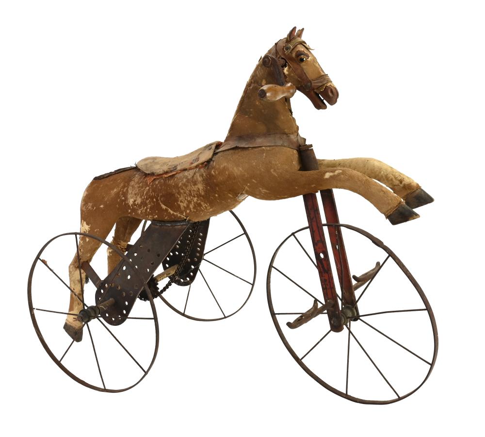 Toy child’s horse tricycle with a brown wooden horse body, large spoked wheels, and a small seat.
