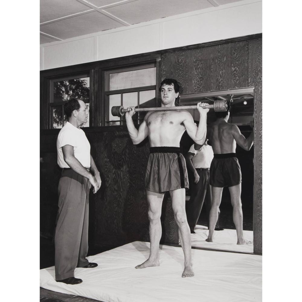 Sid Avery comparable auction result: sid avery 1918 2002 rock hudson lifting weights as his trainer watches saturday evening post 1952