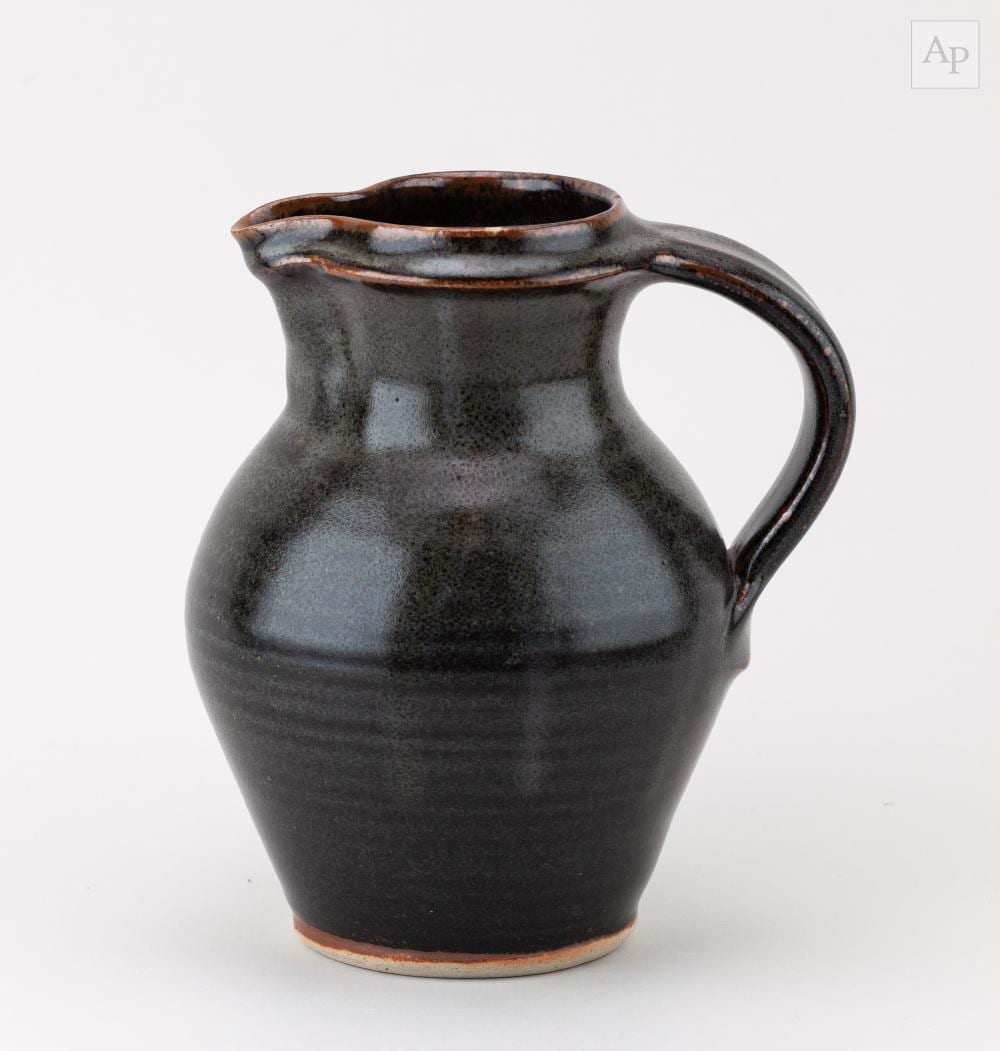 John Leach comparable auction result: john leach 1939 2021 for muchelney pottery a stoneware jug partially covered in tenmoku breaking to kaki glaze impressed jhl and pottery marks dated 2003 height 19cm