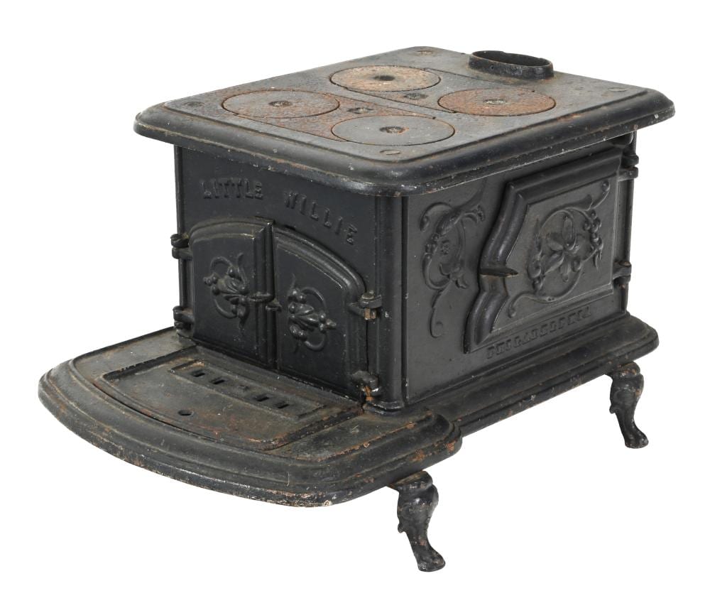 Miniature cast iron stove with a hinged top and front door, featuring a black finish and decorative embossed panels.