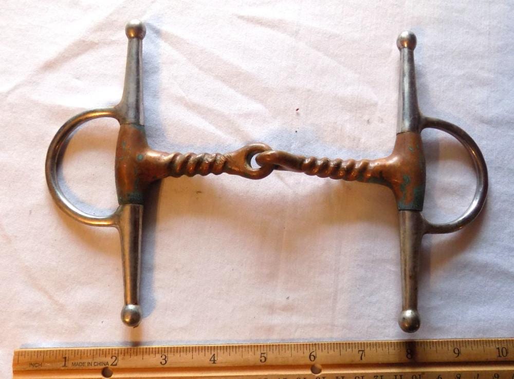 Antique-style horse bridle bit with two metal cheek pieces, a central bar, and loop rings on each side.